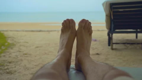 Two feet closeup on the white sand beach blue sky and sea on a holiday Stock Footage 290217609
