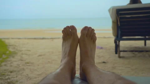 Two feet closeup on the white sand beach blue sky and sea on a holiday Stock Footage 290217616
