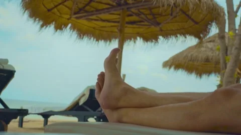 Two feet closeup on the white sand beach blue sky and sea on a holiday Video stock 290218580