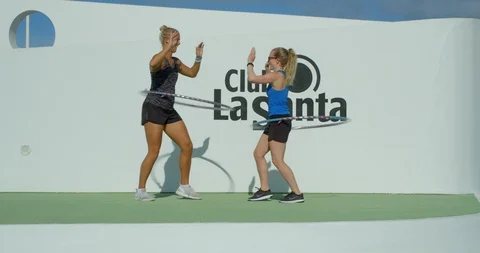 Two female aerobics instructors having fun doing Hula Hoop. Vídeo Stock 86138433
