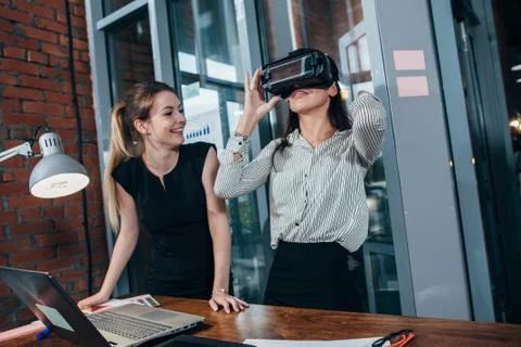 Two female application developers testing a new app designed for VR headset Foto stock