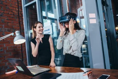 Two female application developers testing a new app designed for VR headset Stock Photos