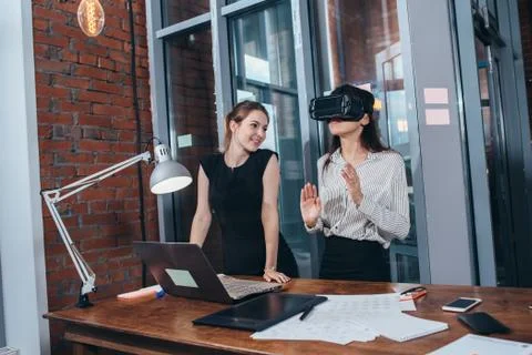 Two female application developers testing a new app designed for VR headset Stock Photos