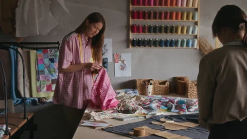 Two Female Artisans Working on Patchwork Garments from Reclaimed Fabrics Stock Footage 315771251