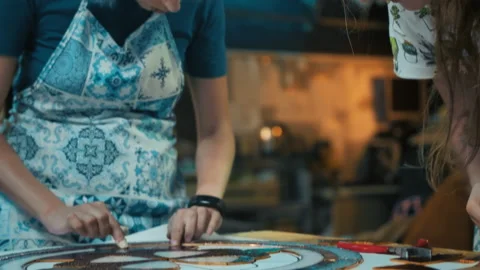 Two female artists assemble a composition from stained-glass windows. Handmade Stock Footage 162340237