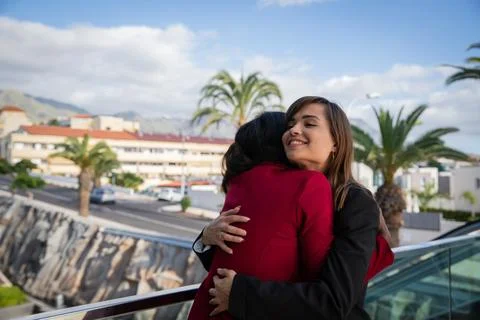 Two female co-workers of different ethnic backgrounds high each other at th.. Stock Photos