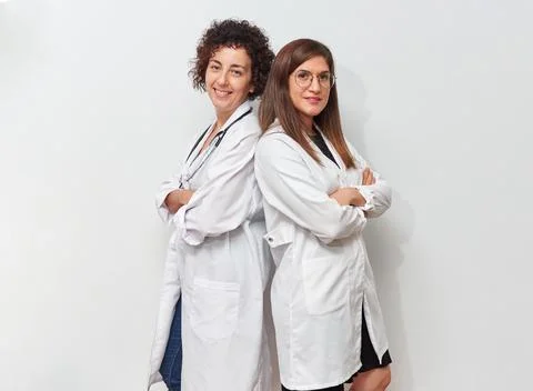Two female doctors posing back to back standing Foto stock