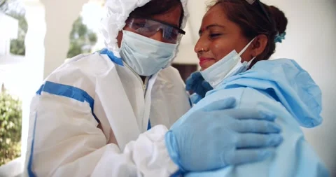 Two female doctors in PPE suits exhausted help bond share with each other Stock Footage 146163896