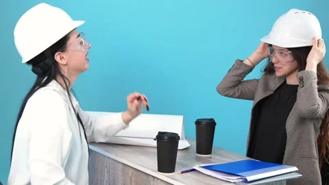 Two Female Engineers Putting on Safety Helmets and Discussing Blueprints at.. Vídeo Stock 346111327