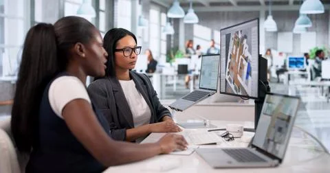 Two Female Engineers Using 3D CAD Software To Design Remodeled Homes. Stock Photos