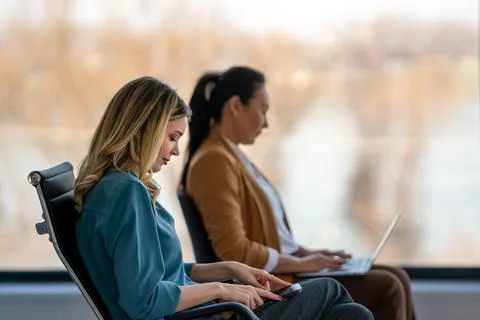 Two female entrepreneurs using computer for a productive business meeting in a Stock Photos