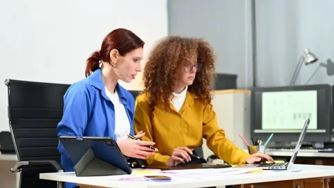 Two female fintech developers collaborating on finance apps, data analytics.. Stock Footage 312387243