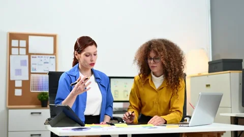 Two female fintech developers collaborating on finance apps, data analytics.. Stock Footage 312387367
