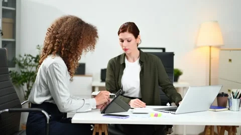 Two female fintech developers collaborating on finance apps, data analytics.. Stock Footage 312387419