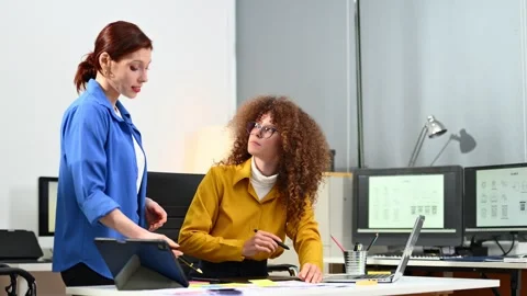 Two female fintech developers collaborating on finance apps, data analytics.. Stock Footage 312603137