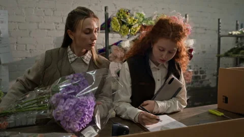 Two Female Florists Scanning Bouquets in Flower Warehouse Stock Footage 343616357