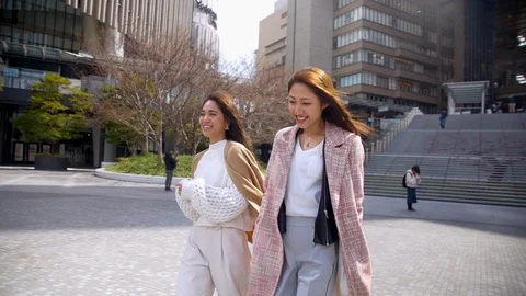 Two female friends exploring city outside Osaka station. HD, Slow motion. Stock Footage 105256162