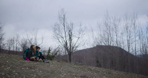 Two Female Friends Take a Break from their Mountain Hike to Enjoy a Hot Stock Footage 343023935