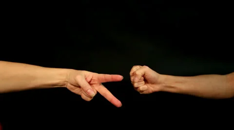 Two female hands are playing rock, paper, scissors Stock Footage