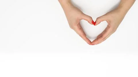 Two female hands folded in the shape of a heart on a white background. Gratit Stock Photos