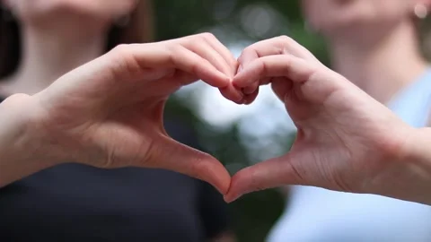 Two female hands make a heart Stock Footage 337632354