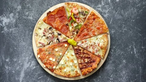 Two female hands take in turn slices of pizza from a spinning tray Stock Footage 130405131