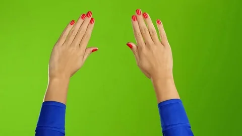 Two female hands waving hello or goodbye. Green screen background Stock Footage