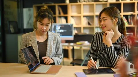 Two female IT developer working together for developing new software at Stock Photos