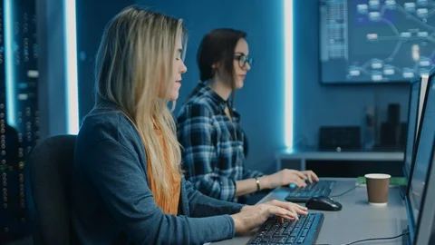 Two Female IT Programers Working on Desktop Computer in Data Center System Stock Footage 103269284