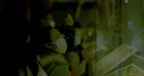 Two female in Mask observe object through glass at exhibition Stock Footage 143402275