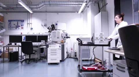 Two female microbiologists greeting each other in a hallway. Stock Footage 57989946