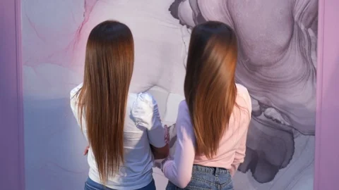 Two female models posing with beautiful long hair Stock Footage 121473280