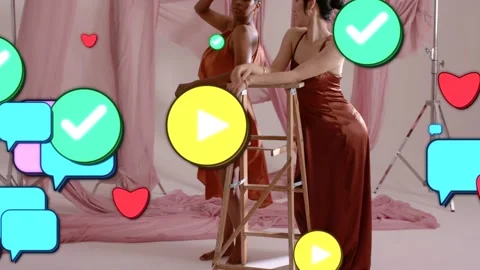 Two female models posing by ladder, social icons floating in, layering over Stock Footage 332612705