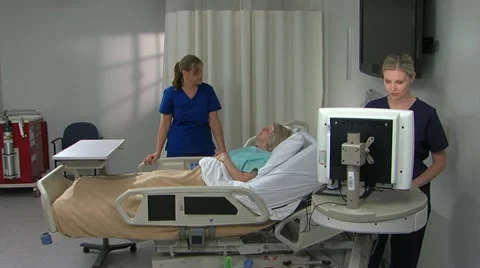Two female nurses with patient in bright room Stock Footage 11140271