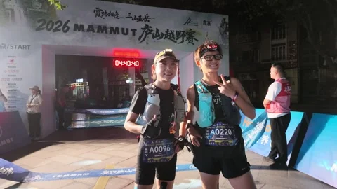 Two Female Runners Gesturing at Start Arch with Red Clock, Lushan Video stock 346701606