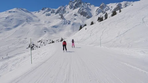 Two Female Skiers Skiing Down The Ideal Slope Of The Mountain In Winter Stock Footage 88665104
