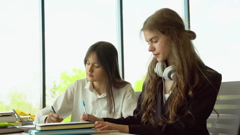 Two female students in the classroom Stock Footage 243323884