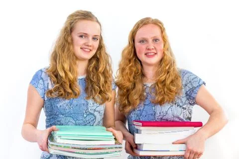 Two female students holding study books Stock Photos