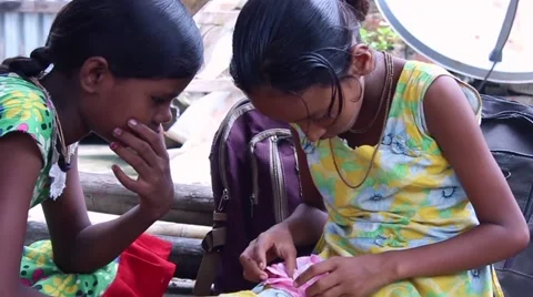 Two female students in India make paper flowers Stock Footage 58812407
