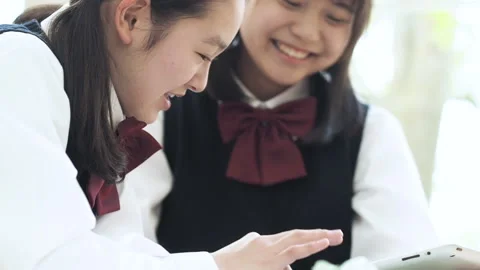 Two Female Students Looking at a Tablet PC Stock Footage 332778512