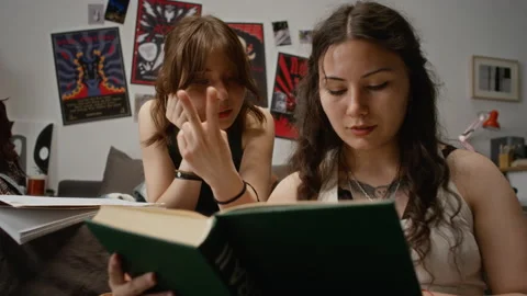 Two Female Students Reading Book, Studying Together for Exam Stock Footage 342832143