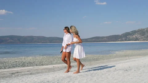 Two female walking at the beach Stock Footage 281789874