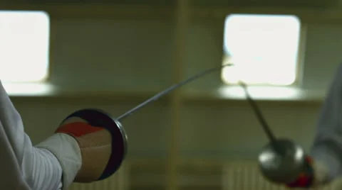 Two fencers fighting in a match, foil, epee, sabre Stock Footage 66436568