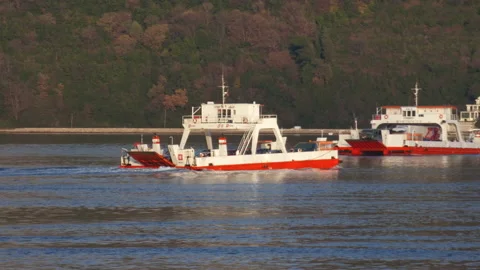 Two ferry boats passing each other:  bright white and red ship at blue sea with Stock Footage 231256916