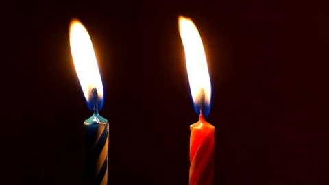 Two festive candles burns in the dark Stock Footage 82369343