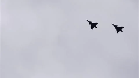 Two Fighter Jets Flying in Formation Through Dramatic Cloudy Sky Видео 334401046