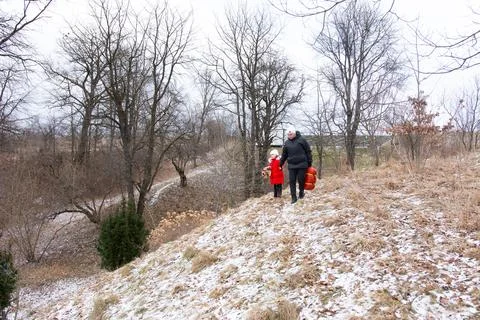 Two figures embark on an adventure through a winter landscape, surrounded by  스톡 사진