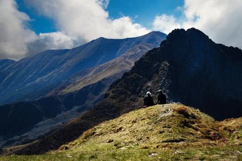 Two figures in high mountains Stock Photos