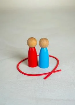 Two figures of human opponents are locked together in a red circle. Working i Stock Photos