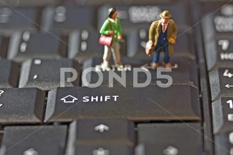 Two figures on keyboard Stock Photos